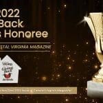 A gold trophy on a marble base beside text reading "Proud 2022 Giving Back Awards Honoree," presented by Coastal Virginia Magazine.
