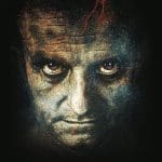 Stylized close-up of a man's face with red cracks, glowing eyes, and speckled texture on black, evoking Frankenstein.