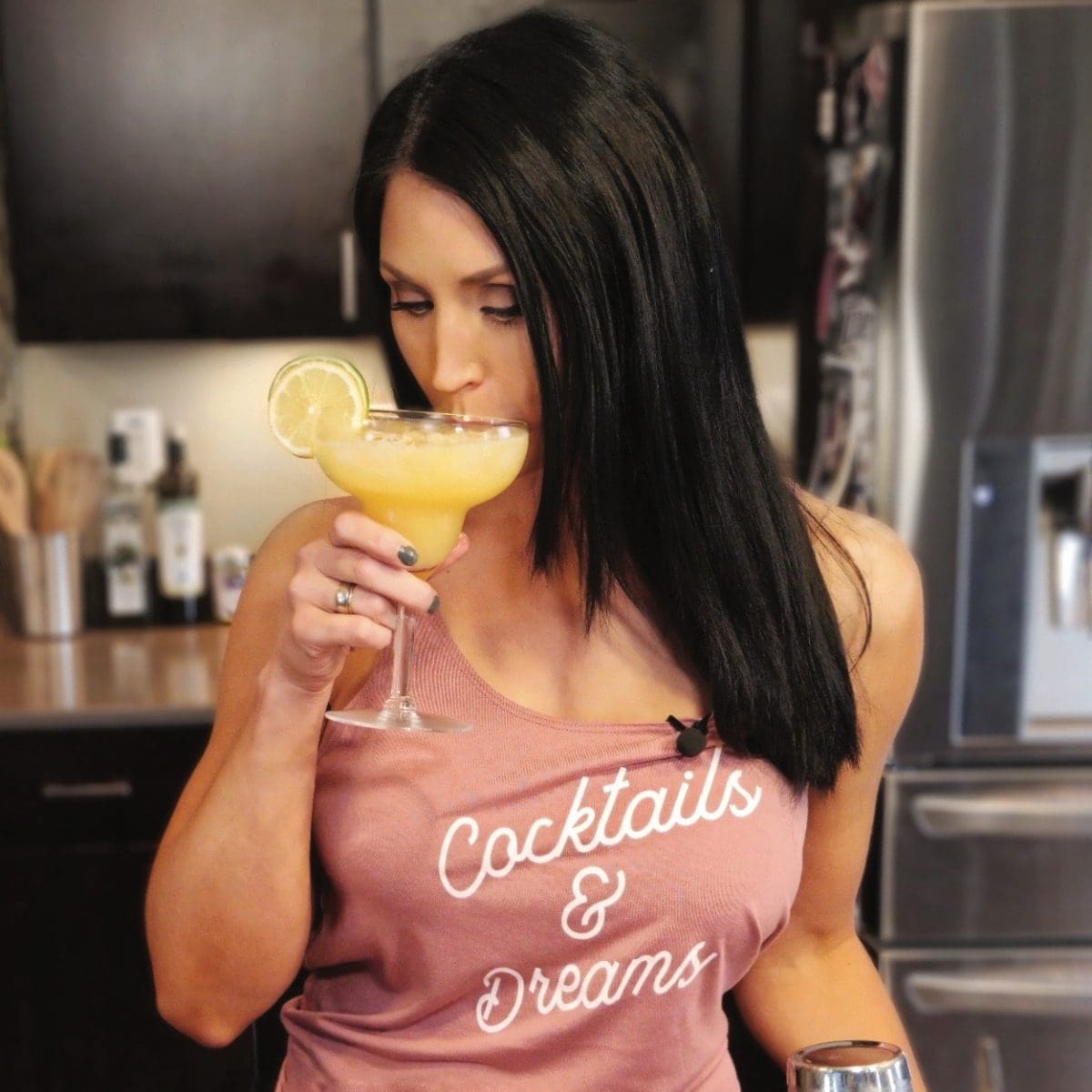 Kristen Crowley drinking a cocktail for her blog Always On