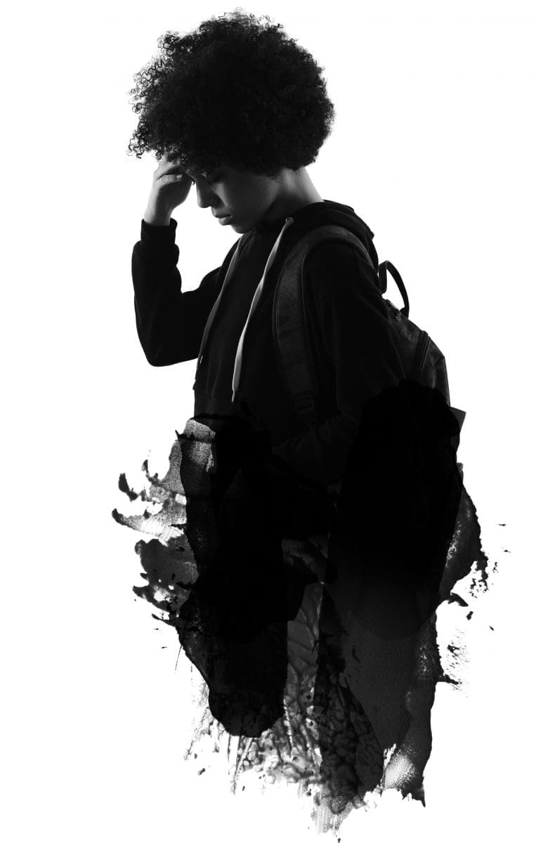 A black-and-white silhouette of a young person with curly hair, hand to head, wearing a backpack, against ink-splatter shapes.