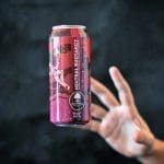 A pink can labeled "Neutral Buoyancy" with an astronaut graphic floats above an outstretched hand against a dark background.