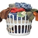 A heaped pile of filthy clothes in a laundry basket, waiting to be washed.