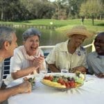 Two senior couples sitting at an outdoor restaurant