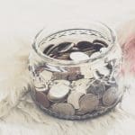 many coins in a money jar with wedding label on jar. wedding concept. saving concept