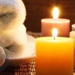 Towel, aromatic candles and other spa objects to make mood relaxing