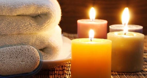 Towel, aromatic candles and other spa objects to make mood relaxing